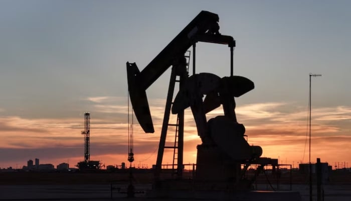 A drone view of a pump jack and drilling rig south of Midland, Texas, US June 11, 2025. — Reuters