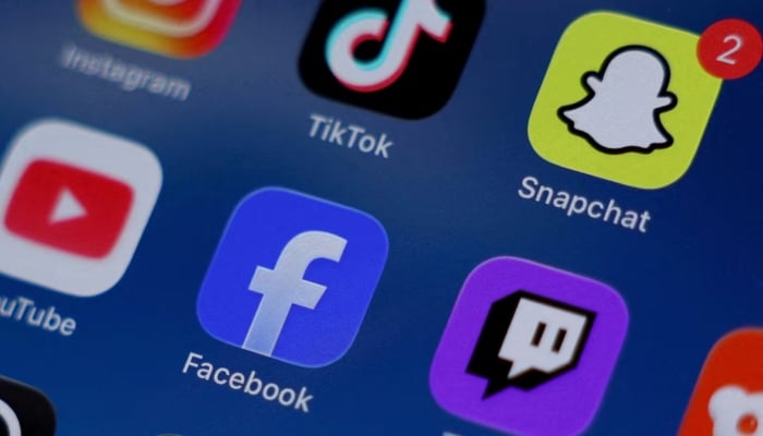 Instagram, TikTok, Snapchat, YouTube, Facebook, Twitch and Reddit applications are displayed on a mobile phone in this picture illustration taken on December 9, 2025. — Reuters