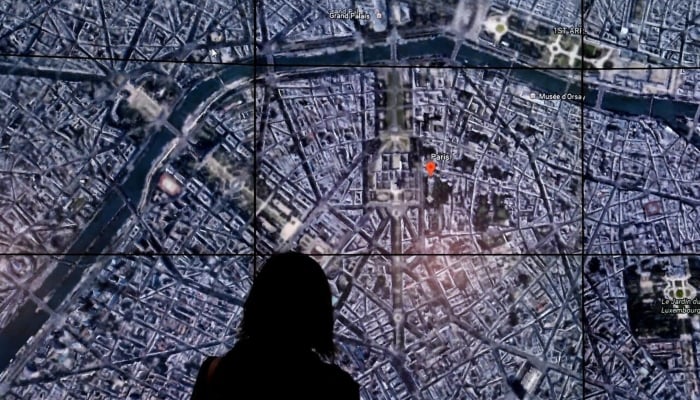 This April 18, 2017, photo shows people viewing a Google Earth map of Paris, France, at an event at New Yorks Whitney Museum of Art. — AFP