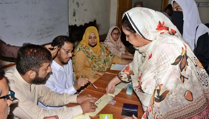 Voters exercising their right of casting vote at a polling station during Azad Jammu and Kashmir (AJK) Refugee Seats elections in Faisalabad, August 2, 2026. — APP