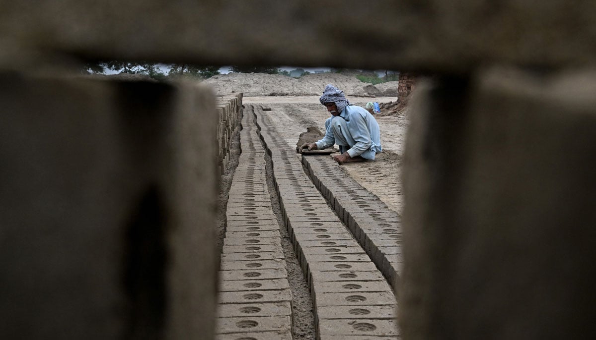 A man works at a brick kiln in Sheikhupura, in Punjab province on July 20, 2026. — AFP