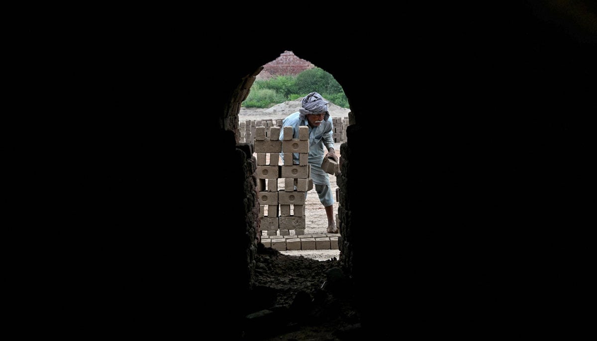 A man works at a brick kiln in Sheikhupura, in Punjab province on July 20, 2026. — AFP