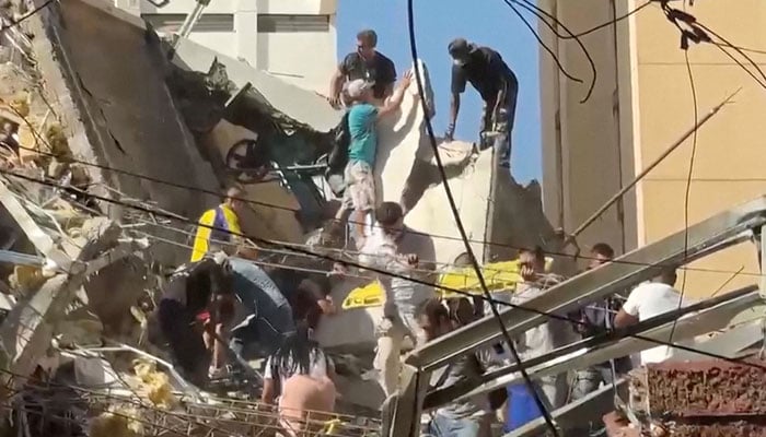 Rescue workers and residents stand atop a collapsed building in the aftermath of an earthquake in Cali, Colombia, August 10, 2026 in this screengrab taken from a video. — Reuters