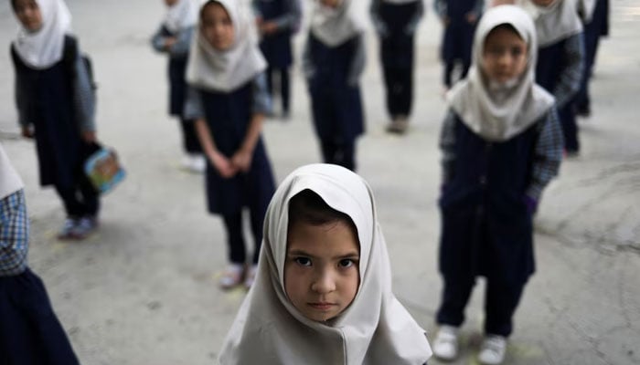 Afghan girls look on at a school in Kabul, Afghanistan, September 18, 2021.— Reuters