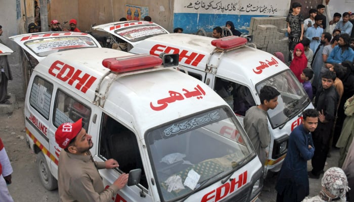 Ambulances are parked at the site of a building collapse in Karachi on February 19, 2026. — Online