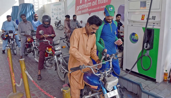 A worker pumps petrol in a motorcycle at a fuel station in Islamabad. —Online/File