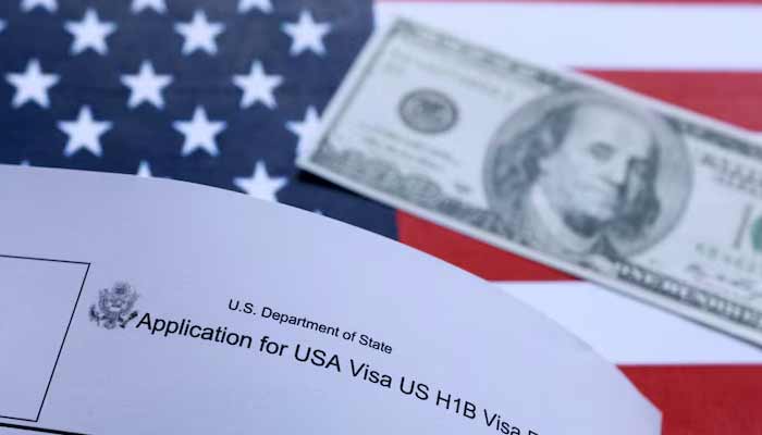 US flag, mock passport, 100 dollar banknote and H-1B visa application form are seen in this illustration taken on September 26, 2025.— Reuters