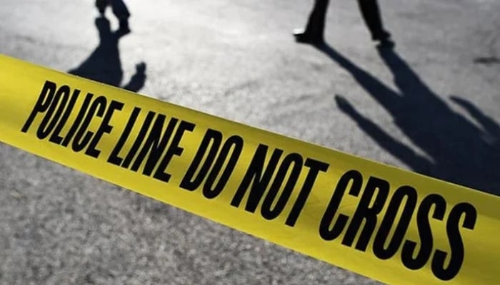 People stand behind a crime scene tape. — AFP/File
