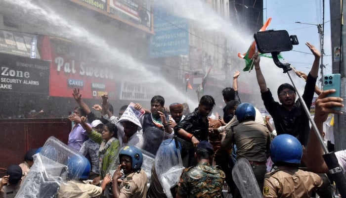 Indian police use water cannon at new protest over test paper leaks