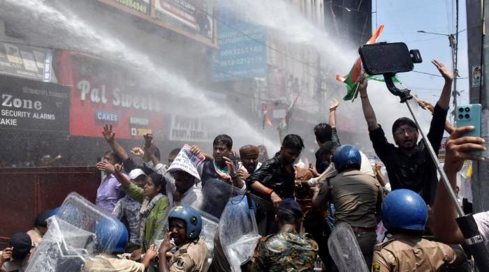 Indian police use water cannon at new protest over test paper leaks