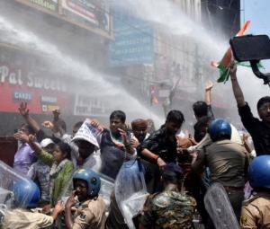 Indian police use water cannon at new protest over test paper leaks
