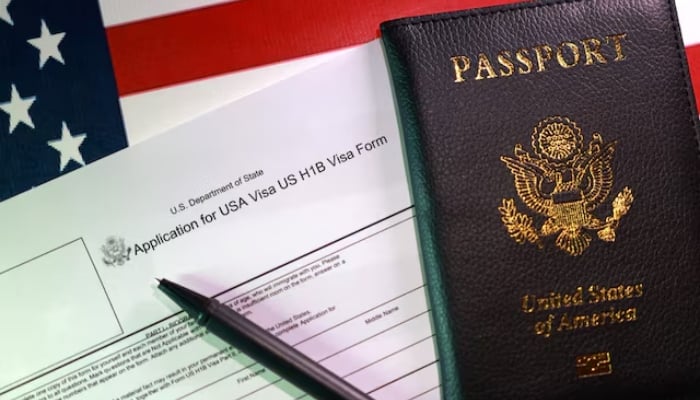 US flag, a passport and a US H-1B Visa application form are seen in this illustration taken, September 22, 2025. — Reuters