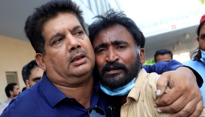 Samiullah, father of a newborn victim, is consoled following a deadly fire at the Pakistan Institute of Medical Sciences (Pims) hospital in Islamabad, August 26, 2026. — Reuters