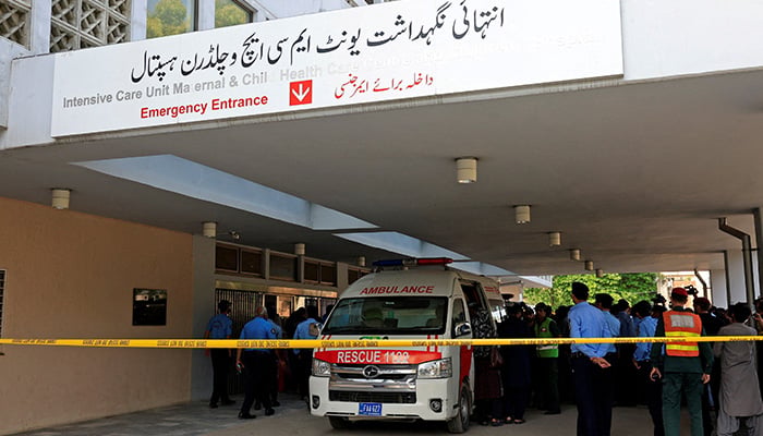 Police officers move past an ambulance outside an intensive care unit after a fire broke out at the Pakistan Institute of Medical Sciences (Pims) hospital in Islamabad, August 26, 2026. — Reuters