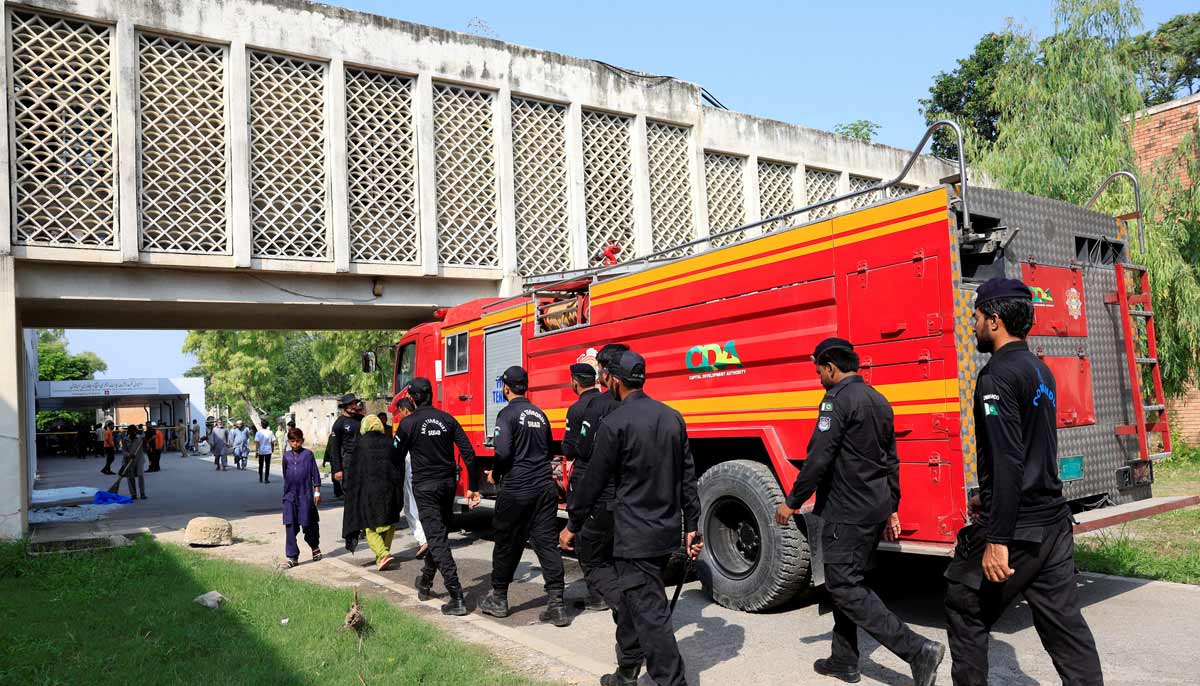 Members of Anti-Terrorist Squad move past a fire engine following a deadly fire at the Pakistan Institute of Medical Sciences (PIMS) hospital in Islamabad, Pakistan, August 26, 2026.— Reuters