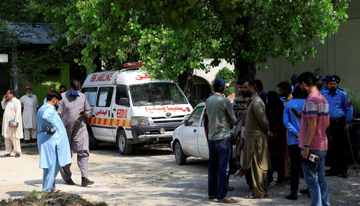Family members and police officers stand outside a mortuary following a deadly fire at the Pakistan Institute of Medical Sciences (PIMS) hospital in Islamabad, Pakistan, August 26, 2026.— Reuters
