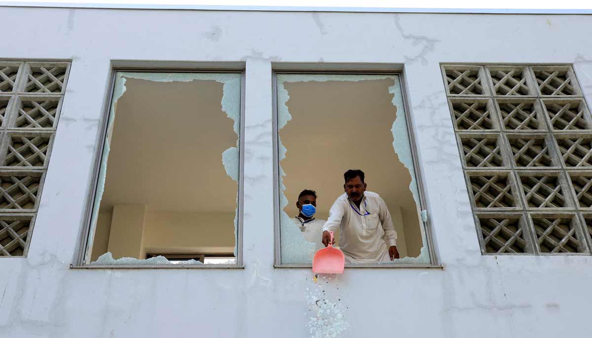 A worker removes broken pieces of a glass window after a fire broke out at the Pakistan Institute of Medical Sciences (PIMS) hospital in Islamabad, Pakistan, August 26, 2026.— Reuters