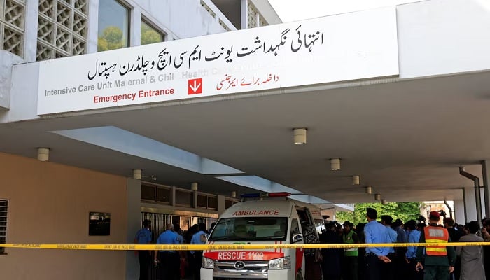 Police officers move past an ambulance outside an intensive care unit after a fire broke out at the Pakistan Institute of Medical Sciences (PIMS) hospital in Islamabad, Pakistan, on August 26, 2026. — Reuters