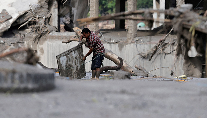 A man salvages his belongings from mud following devastating floods, in Trishuli, Nuwakot district, Nepal, August 27, 2026. — Reuters