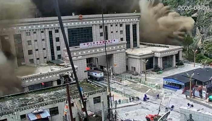 A CCTV footage shows people running away as wall of mud and water destroys buildings in a valley at Nepal-China border, in Gyirong, Tibet region, China August 26, 2026. — Reuters
