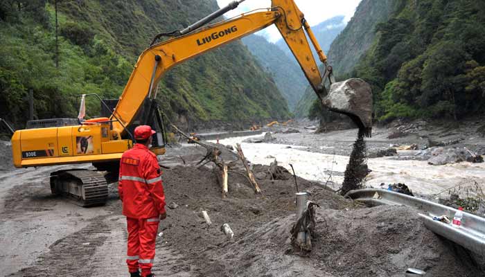 An excavator in action as rescue workers repair a road leading to Gyirong Port after a mudslide, in Gyirong county, Shigatse, Tibet Autonomous Region, China August 28, 2026.— Reuters