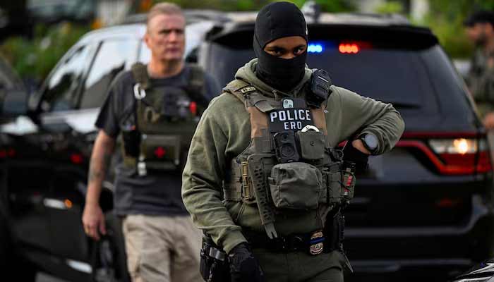 An Immigration and Customs Enforcement (ICE) agent looks on as an individual is detained outside a home in Danbury, Connecticut, U.S., August 27, 2026.— Reuters