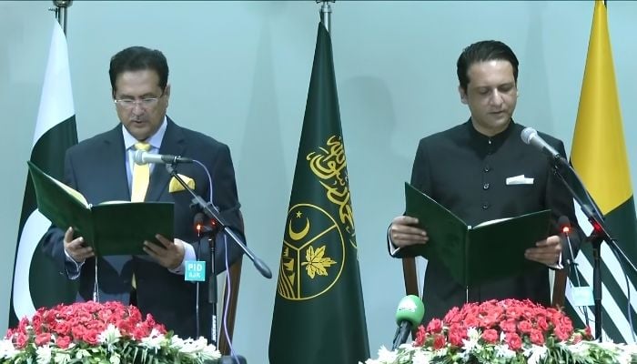 Newly elected Azad Jammu and Kashmir Prime Minister Barrister Iftikhar Gilani (right) takes oath of his oath in a ceremony in Muzaffarabad on August 28, 2026. — Screengrab via Geo News