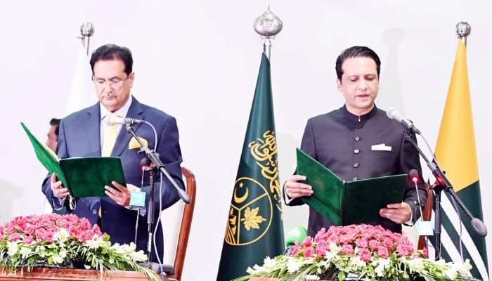 Newly elected Azad Jammu and Kashmir Prime Minister Barrister Iftikhar Gilani (right) takes oath of his office in a ceremony in Muzaffarabad on August 28, 2026. — Facebook/DGPRDIGITALAJK