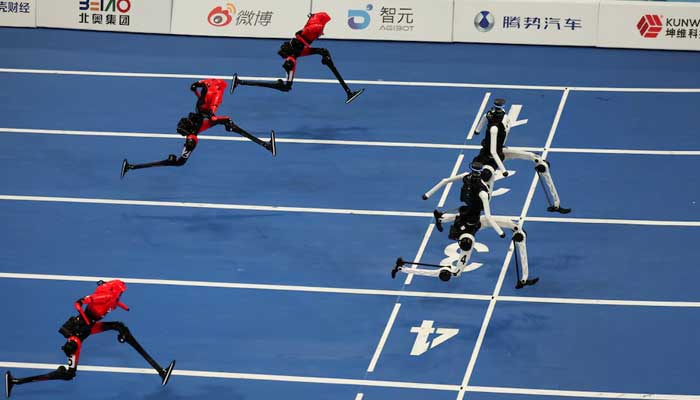 Honor’s Lightning humanoid robots and Tiangong Ultra humanoid robots compete in the 100m large-size group final race, at the 2026 World Humanoid Robot Games at the National Speed Skating Oval in Beijing, China, August 26, 2026. — Reuters
