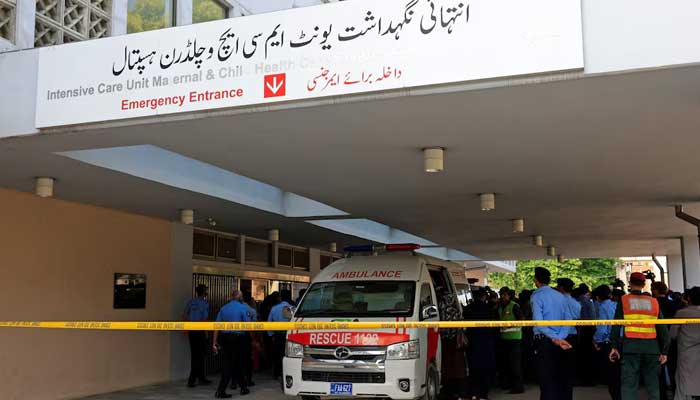 Police personnel move past an ambulance outside an intensive care unit after a fire broke out at the Pakistan Institute of Medical Sciences (Pims) hospital in Islamabad, August 26, 2026. — Reuters
