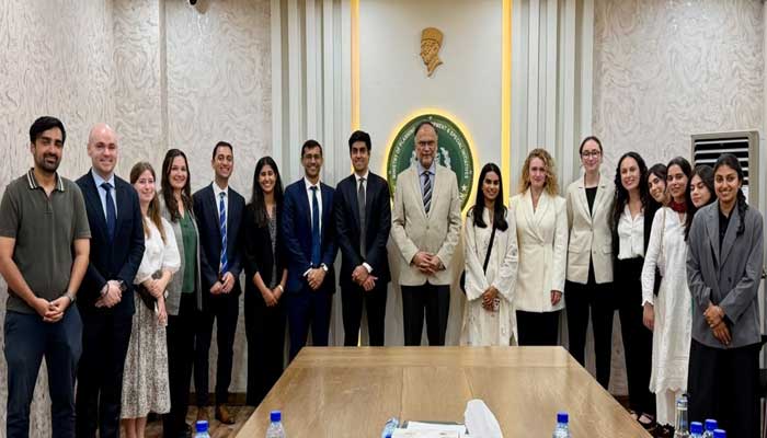 Planning Minister Ahsan Iqbal (centre) poses with the delegation of Harvard Business School MBA students during their visit to the Ministry of Planning and Development in Islamabad on August 28, 2026. — Geo News