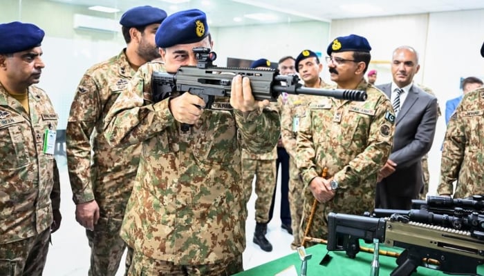 Chief of Defence Forces (CDF) and Chief of Army Staff (COAS) Field Marshal Syed Asim Munir inspects a weapon during his visit to the Pakistan Ordnance Factory (POF) in Wah, August 29, 2026. — ISPR
