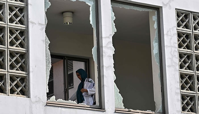 A medical staff member walks past a damaged corridor at the site, a day after a fire at the Mother and Child Health ward of the Pakistan Institute of Medical Sciences (Pims) Hospital in Islamabad on August 27, 2026. — AFP