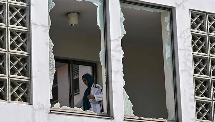 A medical staff member walks past a damaged corridor at the site, a day after a fire at the Mother and Child Health ward of the Pakistan Institute of Medical Sciences (Pims) Hospital in Islamabad on August 27, 2026. — AFP