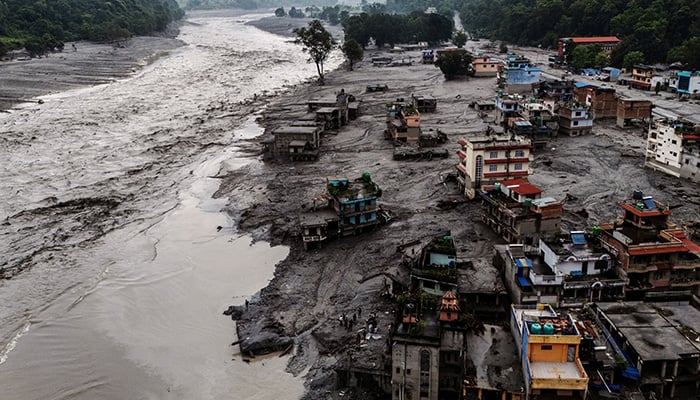 A drone view shows damaged buildings and houses covered in mud next to the Likhu River following deadly flash floods and mudslides, in Devighat, Nuwakot district, Nepal, August 30, 2026. — Reuters