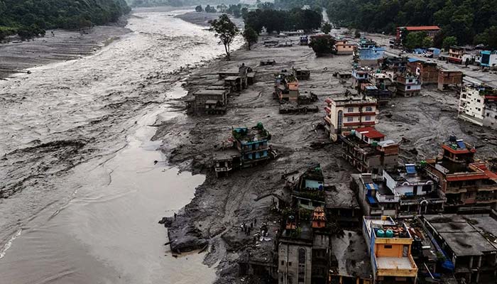 A drone view shows damaged buildings and houses covered in mud next to the Likhu River following deadly flash floods and mudslides, in Devighat, Nuwakot district, Nepal, August 30, 2026. — Reuters