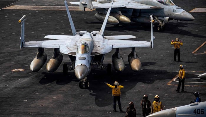 F/A-18E Super Hornets are seen on the flight deck of the USS Gerald R. Ford, March 15, 2026. — AFP