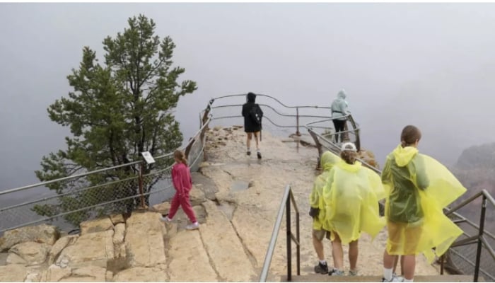 Visitors gather at an overlook of the Grand Canyon on August 31, after a deadly flash flood hit the famed national park. — AFP/File