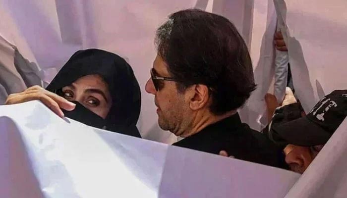 PTI founder Imran Khan and his wife, Bushra Bibi, arrive at the Lahore High Court on May 15, 2023. — AFP