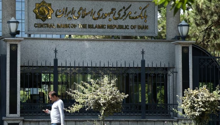 A man walks past the Central Bank of Iran in Tehran, Iran. — Reuters/File