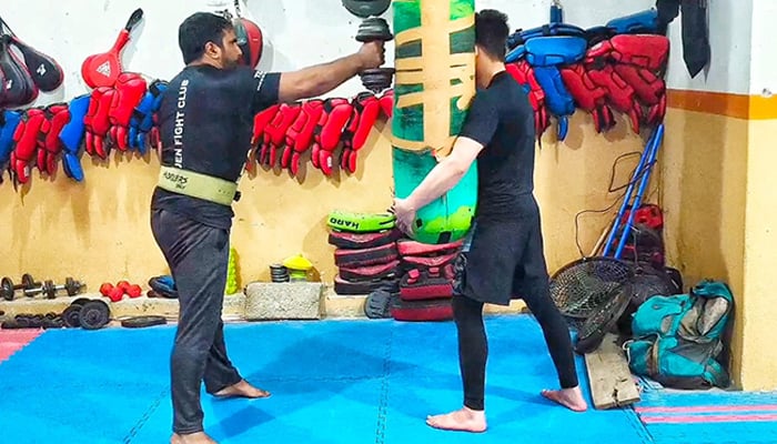 Pakistani martial artist Irfan Mehsood performs 38 full-extension one-hand punches in one minute while carrying a 10-kilogram weight to set another Guinness World Record. — Reporter