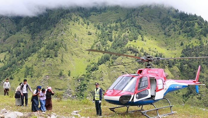Nepal Armed Police Force helicopter carrying relief supply lands for flood affected people in Nepals Rasuwa district on September 1, 2026. — AFP