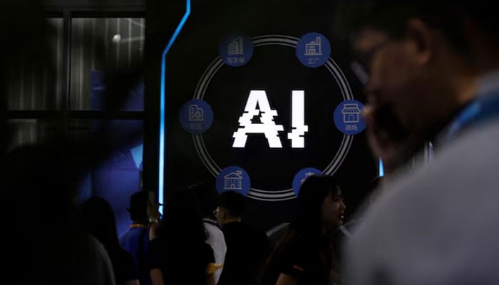 Visitors stand near a sign of artificial intelligence at an AI robot booth at Security China, an exhibition on public safety and security, in Beijing, China June 7, 2023. — Reuters