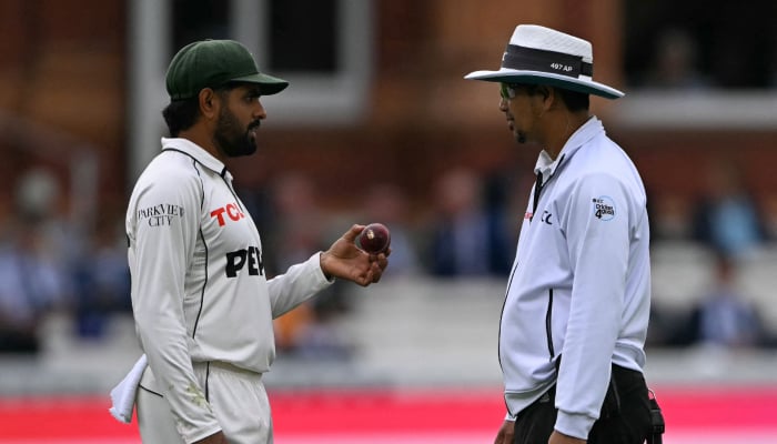 Pakistans Babar Azam talks with an umpire about the ball on day three of the second Test match between England and Pakistan at Lords cricket ground in London on August 29, 2026. — AFP