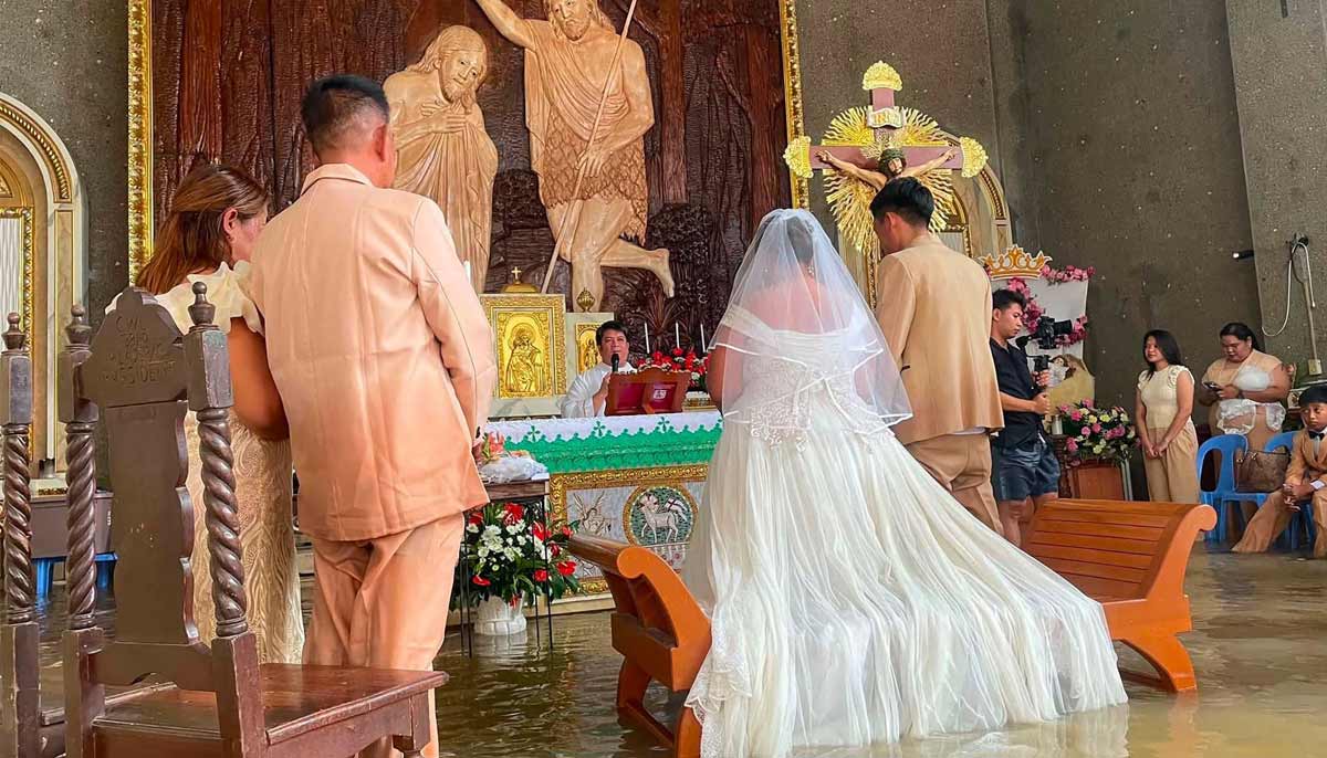 A Philippine couple tied the knot on September 1 at a Catholic church swamped in hip-deep waters, as heavy rains have pummelled large parts of the country for a month.— AFP