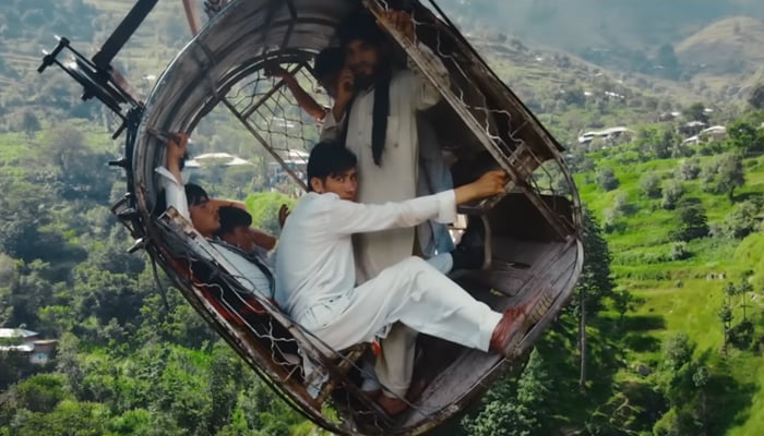 People trapped 900 feet above the ground in a chairlift in Battagram. — YouTube@Abramorama