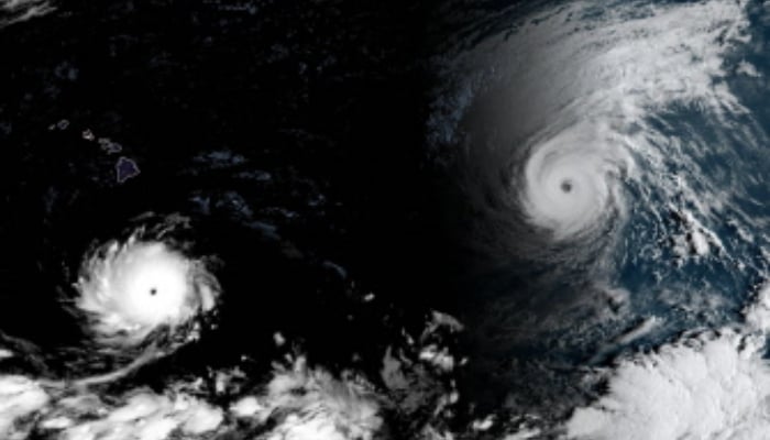 This handout satellite image obtained from the National Oceanic and Atmospheric Administration (NOAA)/GOES shows Hurricane Lowell (L) and Hurricane Karina (R) over the Pacific Ocean on September 2, 2026, at 15:30 UTC. — AFP