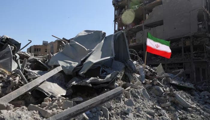 The national flag of Iran flies in the wind as debris lies scattered in the aftermath of an Israeli and US strike on a police station, amid the US-Israeli conflict with Iran, in Tehran, Iran. — Reuters