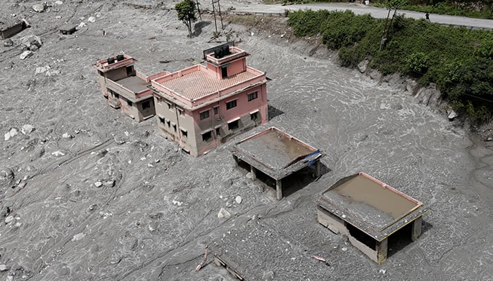 An aerial view shows houses standing amid debris during a helicopter flight from Nuwakot to Rasuwa following the deadly flash floods and mudslides in Nepal, September 3, 2026. — Reuters