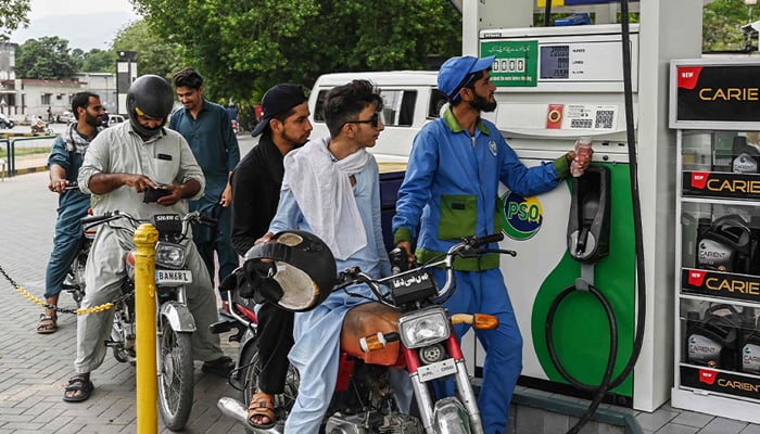 An employee fills the tank of a motorbike at a fuel station in Islamabad on June 16, 2025. — AFP
